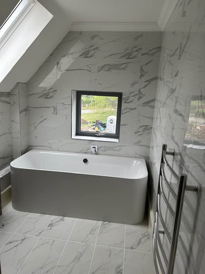 Marble-effect family bathroom with freestanding bath