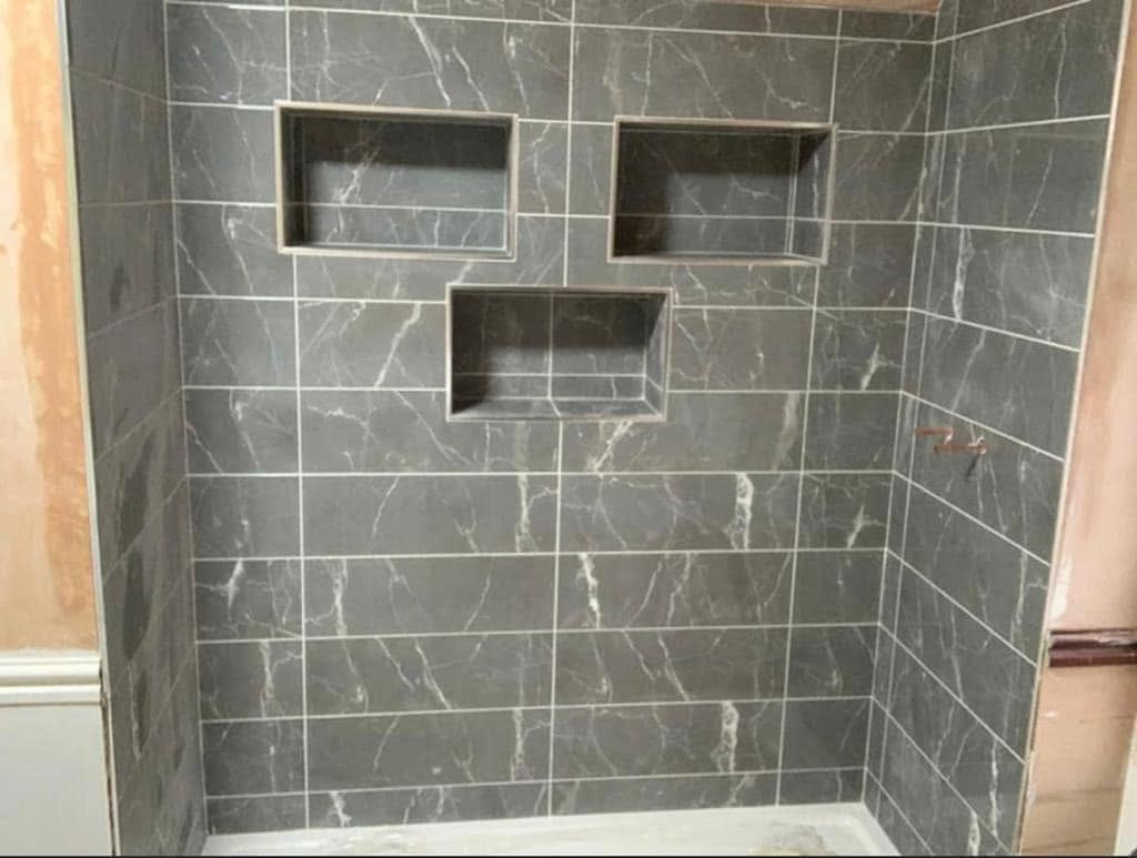Grey marble shower walls with recessed niches