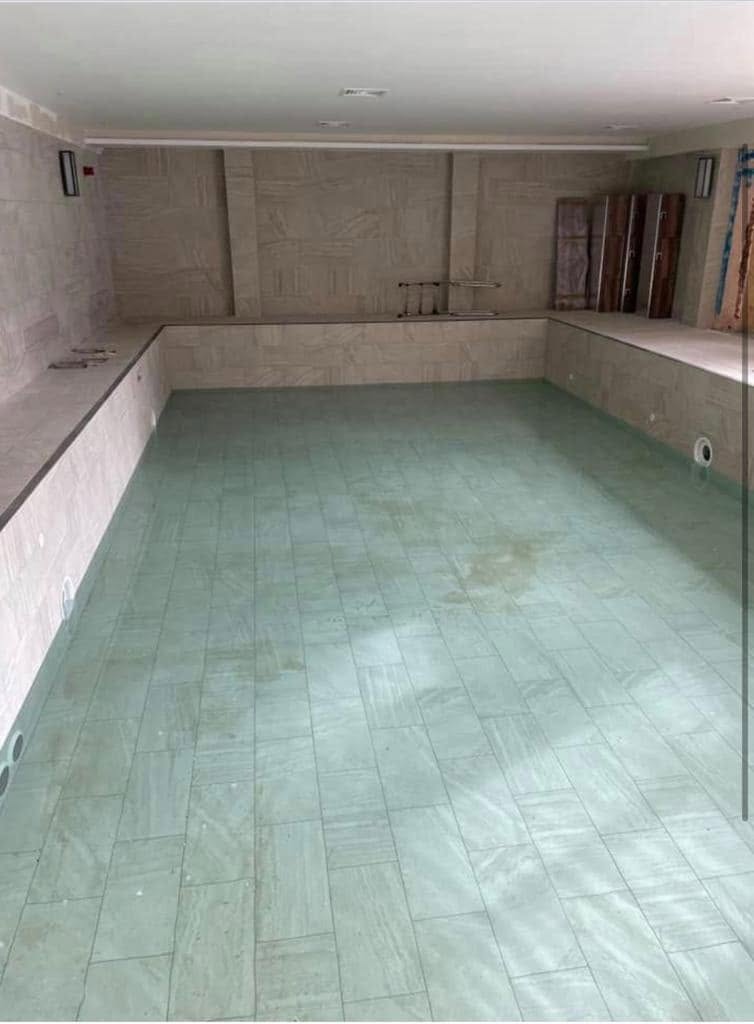 Newly tiled swimming pool shell in stone-effect porcelain